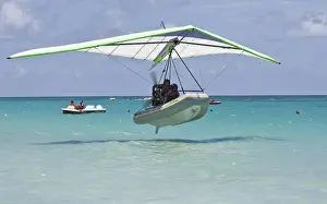 Motorised hang glider landing on the sea