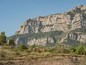 Mountain backdrop with green vegetation and blue sky