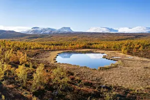 Mountain group Lapporten reflected in small pond