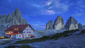 Mountain hut Dreizinnenhuette with rock massif Paternkofel and mountains three peaks at night