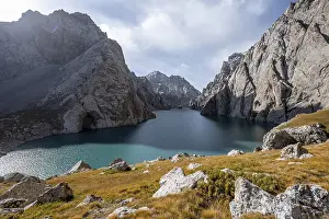 Mountain lake Kol Suu rocky steep mountains