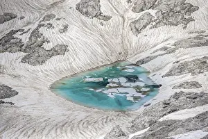 Mountain lake, snow remains, high alpine landscape