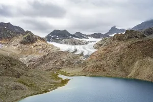 Mountain lake Vogelhuettensee, high mountain landscape with glacier Uebeltalferner in the background