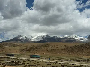 Mountain landscape and lorries in the highlands of Tibet along the Tibet Railway