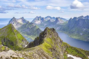 Mountain landscape with steep rocky peaks fjords and sea