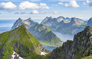 Mountain landscape with steep rocky peaks fjords and sea