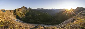 Mountain landscape at sunrise with sun star