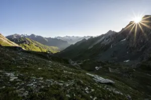 Mountain landscape at sunrise with sun star