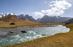 Mountain landscape with yellow meadows and river Kol Suu