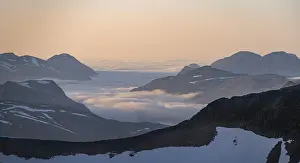 Mountain panorama with clouds in the valley