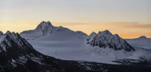 Mountain panorama and glacier at sunrise