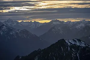 Mountain panorama with snow at sunset