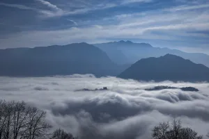 Mountain Peak Above Cloudscape in a Sunny Day in Lugano