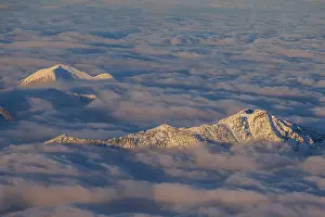 Mountain peak above high fog, evening light
