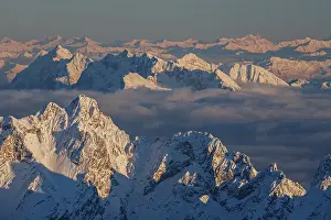Mountain peak above high fog, evening light