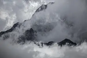 Mountain peak rises out of clouds