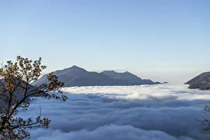 Mountain Range Above Cloudscape with Sunlight and Clear Sky in Lugano