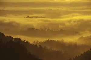 Mountain range view from peak in misty morning sunrise