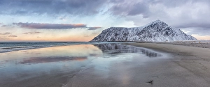 A mountain reflected in the water of the ocean at Skagsanden beach