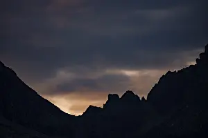Mountain ridge with cloudy sky at blue hour