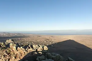 Mountain shadow in the shape of a triangle in the landscape
