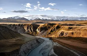 Mountain stream Sary Jaz, behind Glaciated and snow-covered mountains