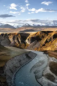 Mountain stream Sary Jaz, behind Glaciated and snow-covered mountains