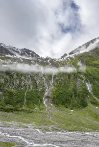 Mountain streams flow over steep mountain slopes into the Schlegeisgrund valley