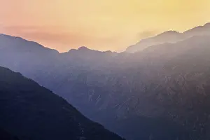Mountain sunset and colored sky with clouds