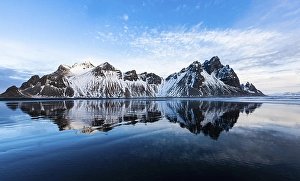 Mountain Vestrahorn with water reflection in the bay of Hornsvik