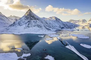 Mountain Volandstinden reflected in Fjord