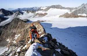 Mountaineer climbing on a rocky ridge on the mountain peak Wilder Freiger