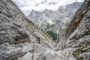 Mountaineer climbing in steep rocky terrain on the way to Waxenstein