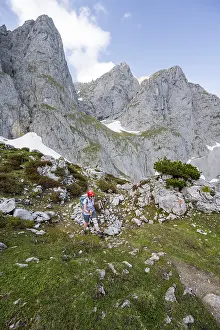 Mountaineer with helmet on a hiking trail