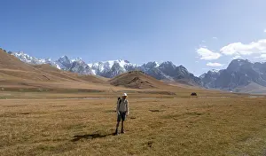 Mountaineer hiking to the mountain lake Kol Suu