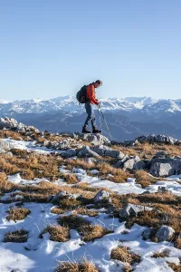 Mountaineer hiking in front of mountain panorama