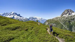 Mountaineer on hiking trail, mountain panorama with glaciated mountain peaks