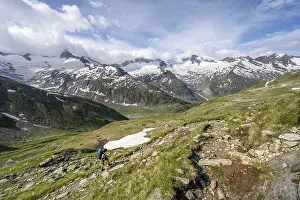Mountaineer on hiking trail in picturesque mountain landscape