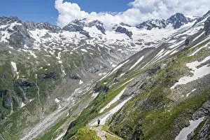 Mountaineer on hiking trail in picturesque mountain landscape