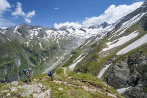 Mountaineer on hiking trail in picturesque mountain landscape