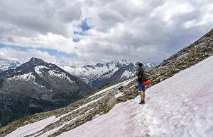 Mountaineer on hiking trail with snow