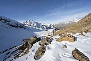 Mountaineer on a hiking trail with snow