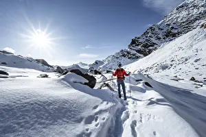 Mountaineer on a hiking trail with snow on the Ramoljoch
