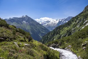 Mountaineer on a hiking trail by a stream