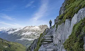 Mountaineer on a hiking trail, view of mountain panorama