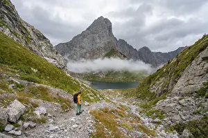 Mountaineer on a hiking trail with a view of rocky
