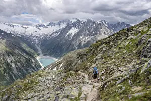Mountaineer on hiking trail, view of Schlegeisspeicher