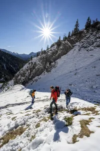 Mountaineer on hiking trail in winter with snow