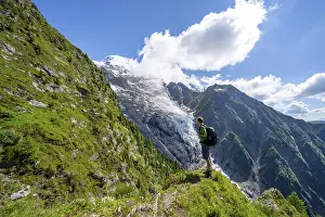 Mountaineer in front of impressive mountain landscape with glacier