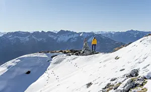 Mountaineer looks over snow-covered mountains